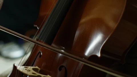 Man playing a cello with camera tilting up Stock Footage 109270087