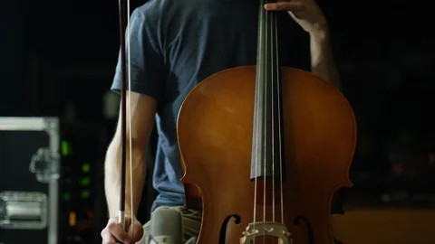 Man playing a cello with camera tilting up Stock Footage 109270759