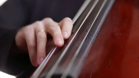 Man playing the cello finger closeup. Video stock 72650216
