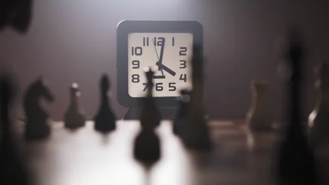 A man playing chess on chessboard in a dimly lit room Stock Footage 312825196