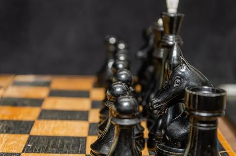 Man playing chess on a chessboard Stock Photos