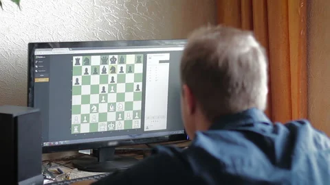 A man playing chess with a computer or online rival Stock Footage 86485224