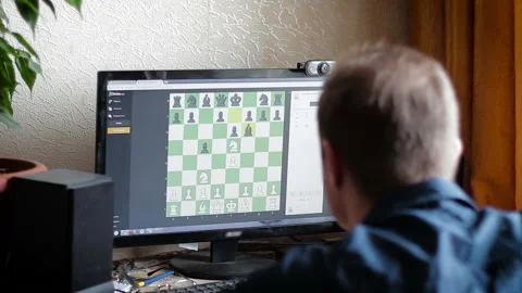 A man playing chess with a computer or online rival Stock Footage 86700542