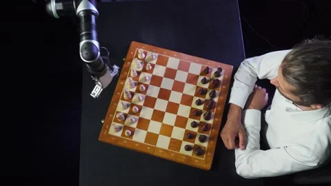 Man playing chess with a robot, the confrontation between man and artificial Stock Footage 133218226