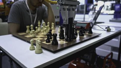 Man is playing chess with robot. Media. Man is playing chess against robot at Stock Photos