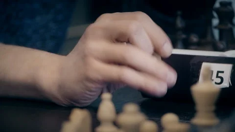 Man playing chess at the table, hands close-up waiting for the move Stock Footage 125416760