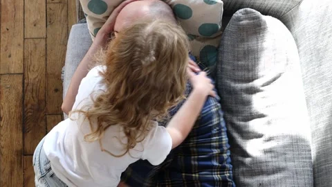 Man playing with a child on the couch. Stock-Footage 254914582