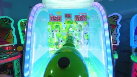 A man playing a children's game machine knocks down toys, hands can be seen Stock Footage 237309604