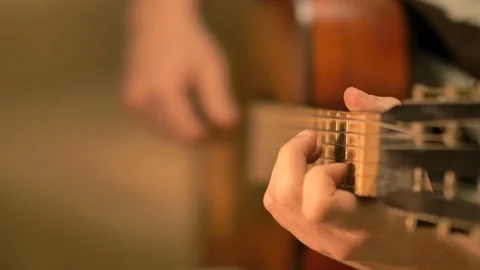 A man playing chords on an old classic guitar Stock Footage 120183564