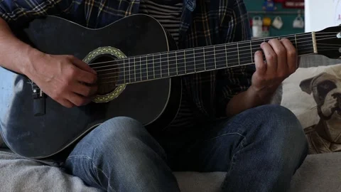 Man playing classical guitar at home. Stock Footage 244878049