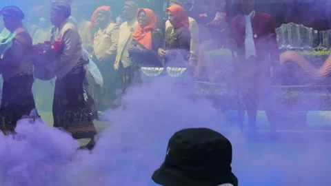 Man playing colored smoke during traditional dance performance in Central Stock Footage 237141061