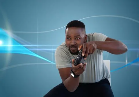 Man playing with computer game controller with blue curved background Stock Photos