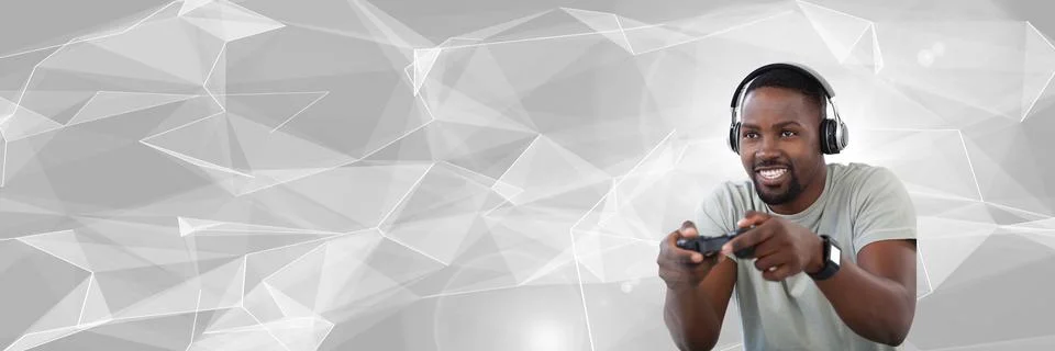 Man playing with computer game controller with bright polygon background Foto stock