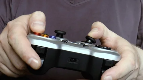 Man playing a computer game holding a joystick Stock Footage 79410985