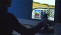 The man playing in computer game with a joystick. evening night time 4k or 4k+ Resolution