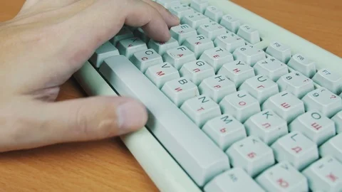 A man playing a computer game, the keyboard controls Stock Footage 70169729