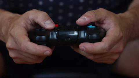 Man playing on a console with a gamepad. Stock-Footage 252323343