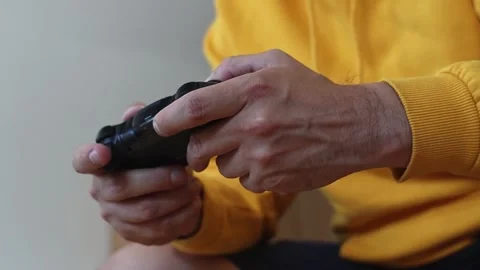 Man playing on a console with a gamepad. Stock-Footage 252323782