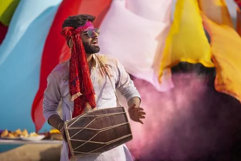 Man playing on a dhol, during holi celebrations Stock Photos