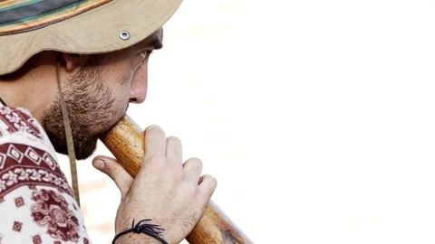 Man playing the Digeridoo. White Bacground Stock Footage 89413583