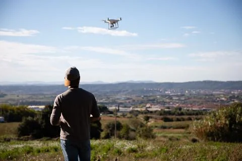 Man playing with drone on the open field Stock Photos