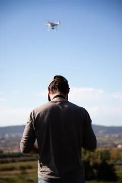 Man playing with drone on the open field Stock Photos
