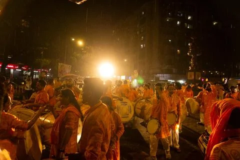 Man playing drum dhol during visharjan Stock Photos