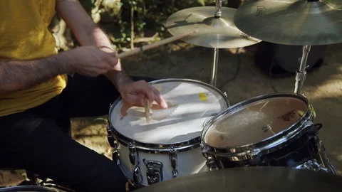Man playing drum in the open air on a sunny weeather Stock Footage 116259121