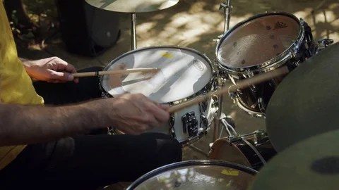Man playing drum in the open air on a sunny weather Stock Footage 116259157