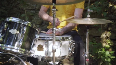 Man playing drum in the open air on a sunny weeather Stock Footage 116259815