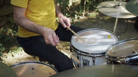 Man playing drum in the open air on a sunny weather Stock Footage 116260473