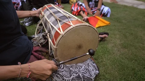 Man playing the drum sitting on the ground 스톡 동영상 111899783