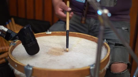 A man is playing drums with a microphone in front of him Stock Footage 331193958