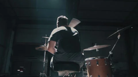 Man playing the drums in warehouse Stock Footage 275101580