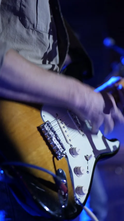 Man playing an electric guitar during a concert Stock Footage 233242519