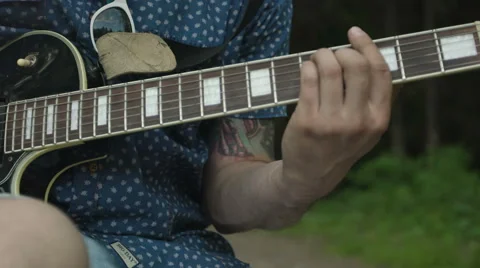 Man is playing at the electric guitar in forest Stock Footage 68349675