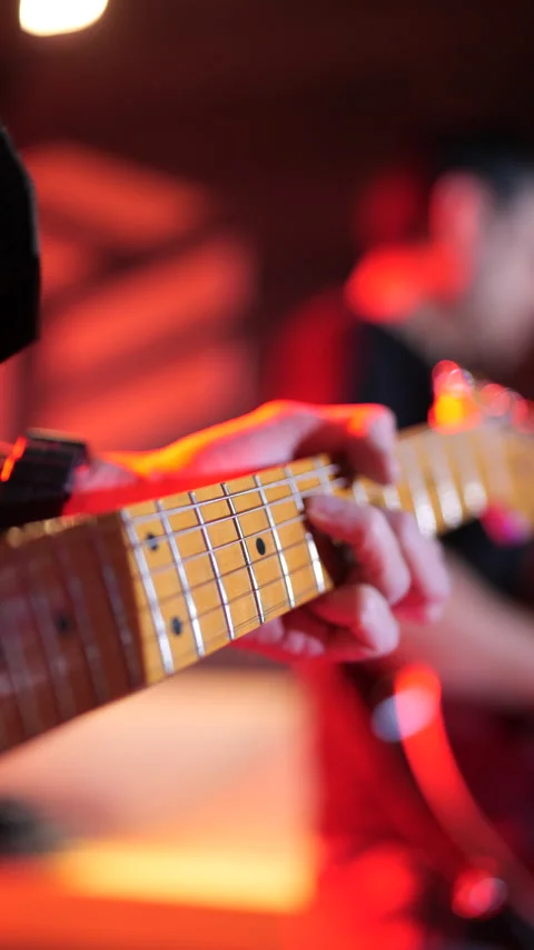 Man playing the electric guitar, no faces are shown. Stock Footage 233242518