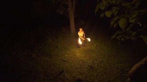 Man playing with fire in forest at night 스톡 동영상 72506894