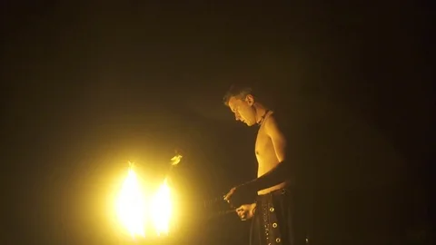 Man playing with fire at night in slow motion Stock Footage 72506672