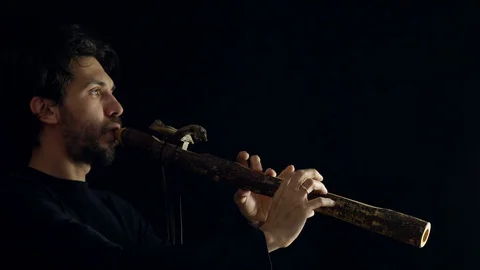 Man playing the flute Stockbeeldmateriaal 99956567