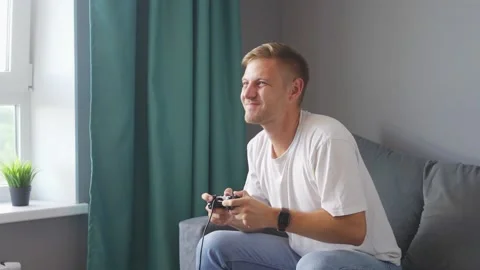 A man playing a game console at home Stock Footage 219530704