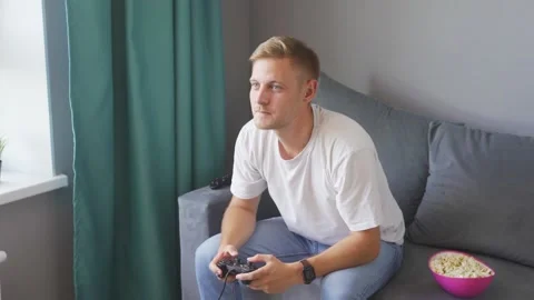 A man playing a game console at home Stock Footage 219530745