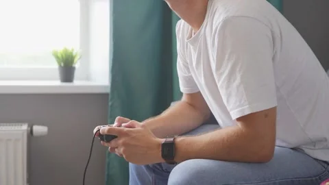 A man playing a game console at home Stock Footage 221260658