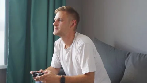 A man playing a game console at home Stock Footage 221260682