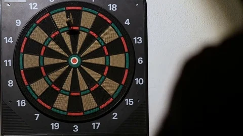 Man playing a game of darts, focus on target Stock Footage 76410990