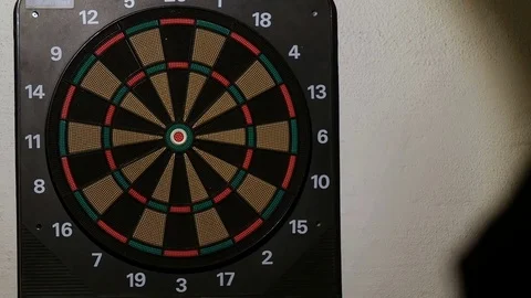 Man playing a game of darts, focus on target Stock Footage 76412041