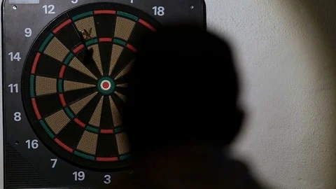 Man playing a game of darts, focus on target Stock Footage 76412652