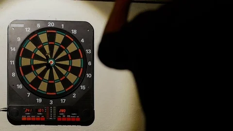 Man playing a game of darts, focus on target Stock Footage 76412960