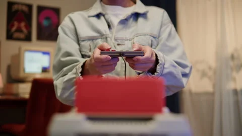 Man playing a game on retro style console, enjoying and play vintage old video 스톡 동영상 218273536