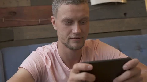 Man playing game on smartphone Stock Footage 95218189